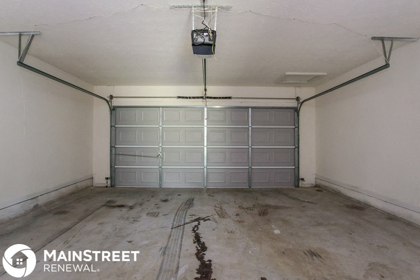 the inside of a garage with a cracked floor
