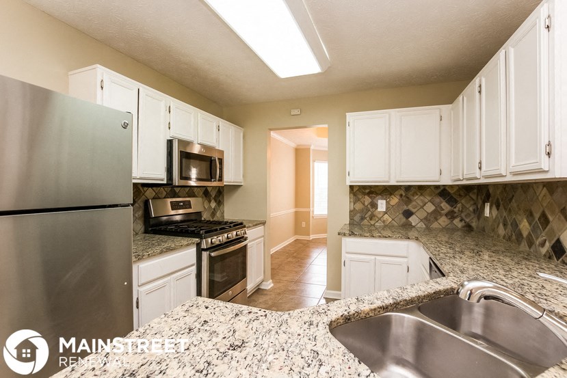 a kitchen with granite counter tops and stainless steel appliances