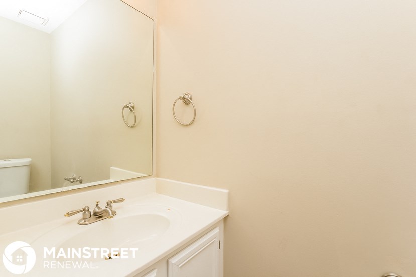a white bathroom with a sink and a mirror