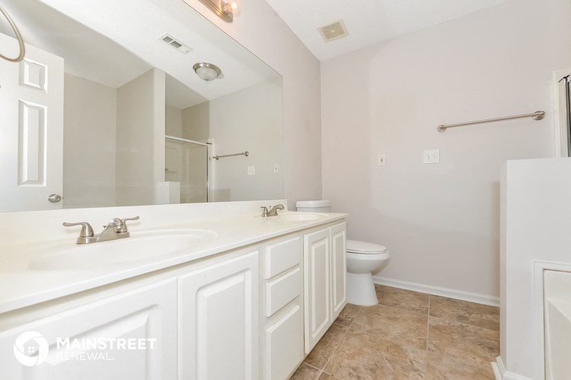 a bathroom with a sink and a toilet and a mirror