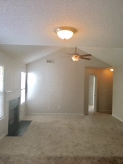 an empty living room with a ceiling fan