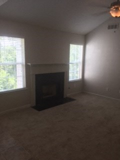 an empty living room with a fireplace