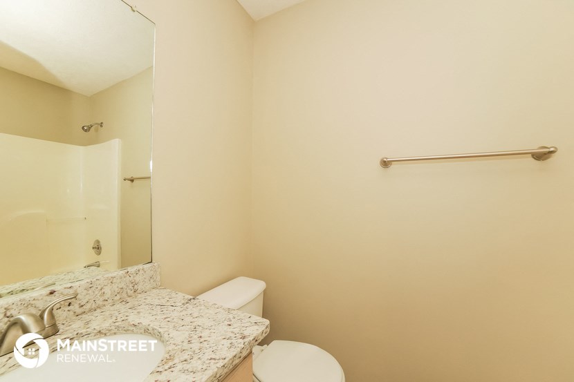 a bathroom with a sink and a toilet and a mirror