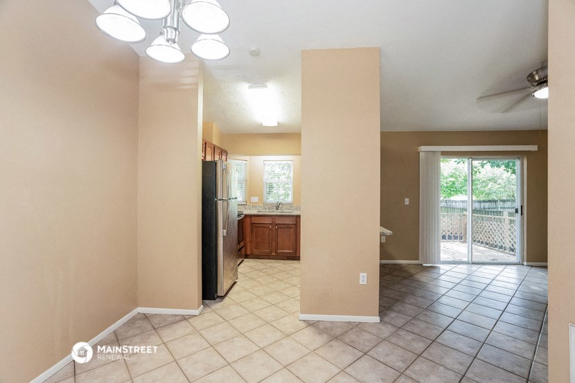 an empty kitchen with a sliding glass door to a patio
