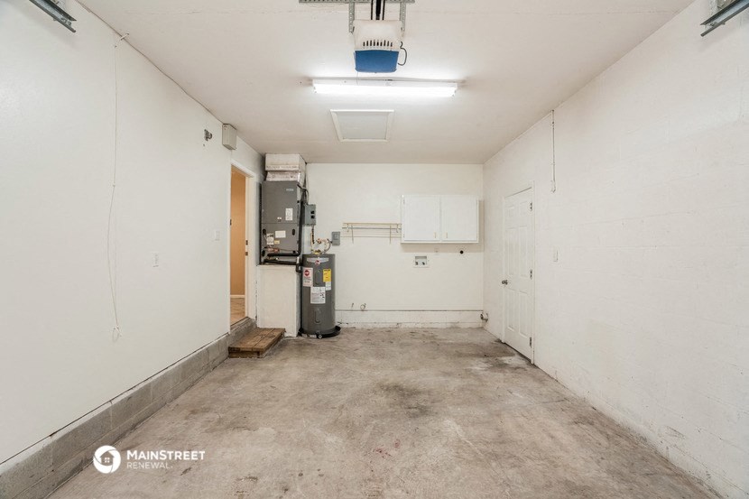 the interior of a room with white walls and a concrete floor