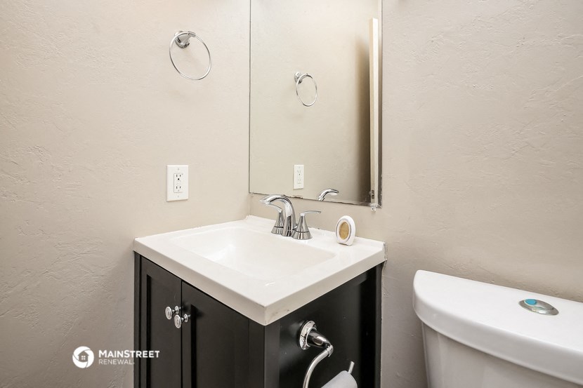 a bathroom with a sink and a mirror and a toilet