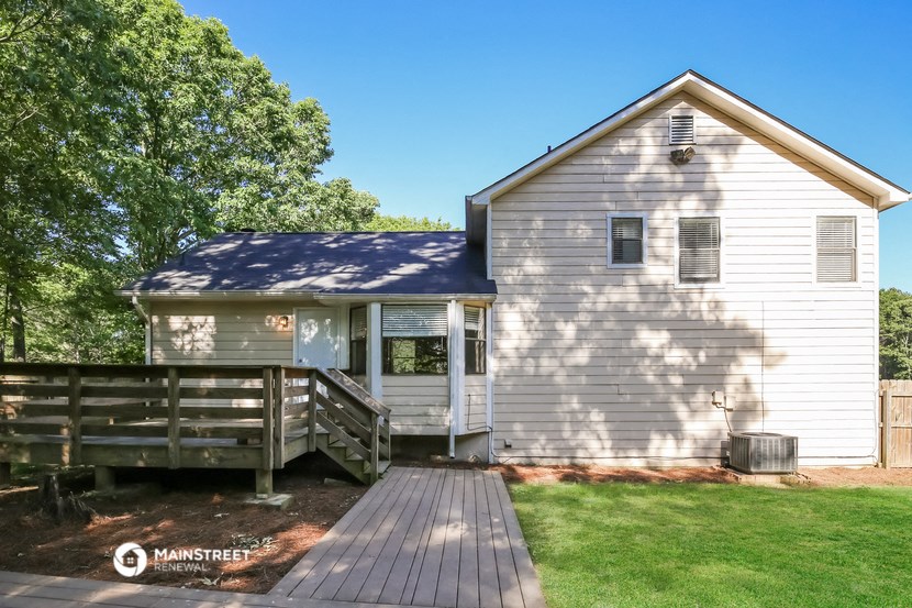 a small white church with a wooden deck in front of it