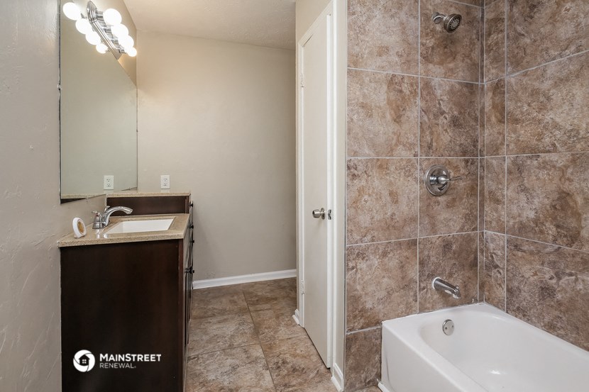 a bathroom with a sink and a tub and a shower