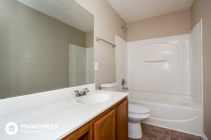 a bathroom with a sink and a toilet and a tub