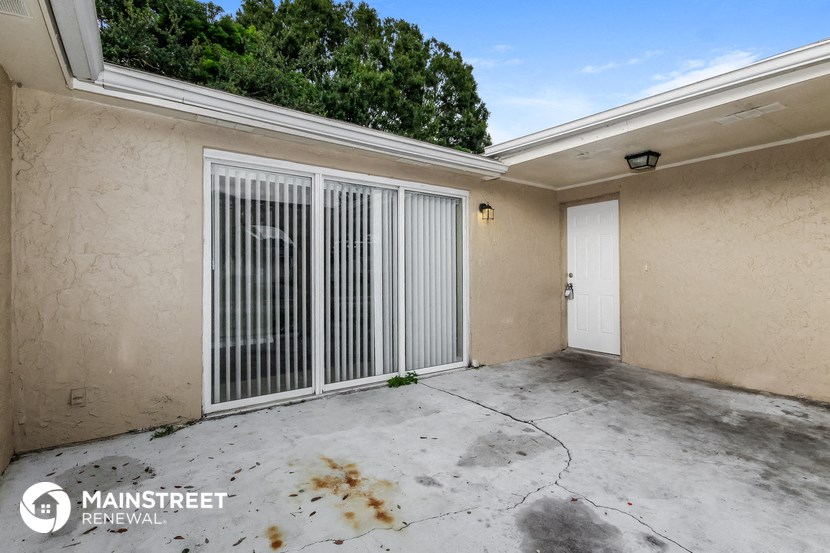 the garage in the yard of a home with a white door