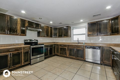 a kitchen with wooden cabinets and stainless steel appliances