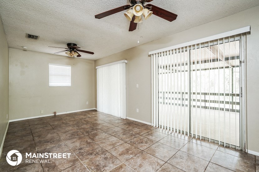 the living room has a large sliding glass door to the patio