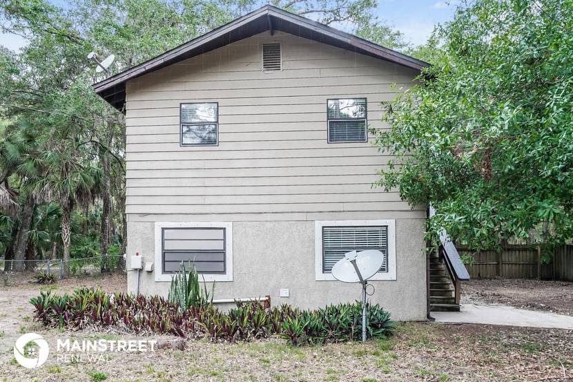 a small house with a satellite dish in front of it