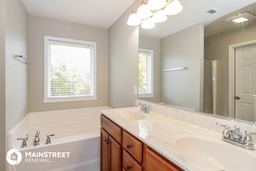 a bathroom with two sinks and a large mirror