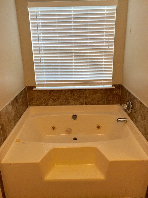a bath tub in a bathroom with a window