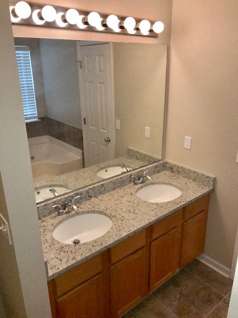 a bathroom with two sinks and a mirror