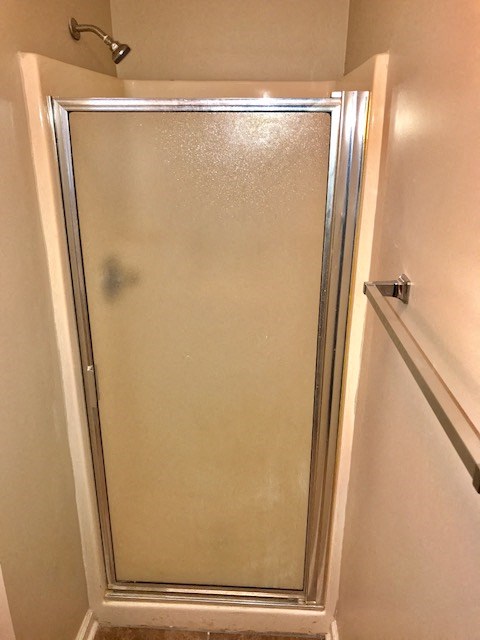 a shower in a bathroom with a glass door