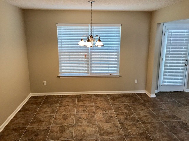 a dining room with a window and a chandelier