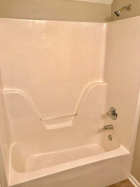 a white bathroom with a tub and a sink