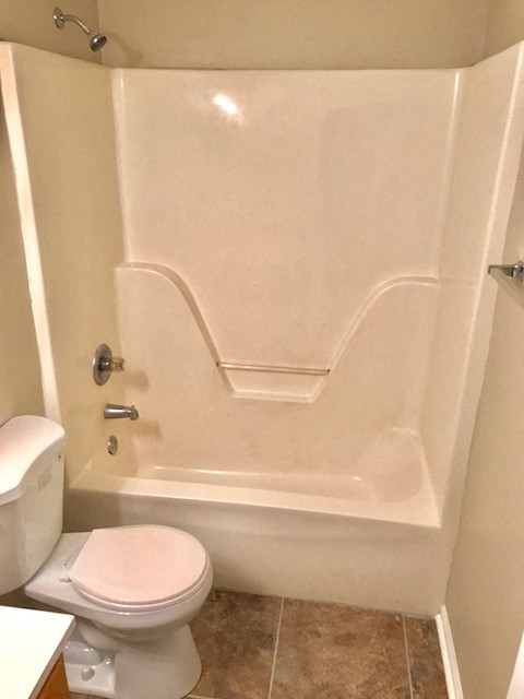a bathroom with a toilet and a bath tub