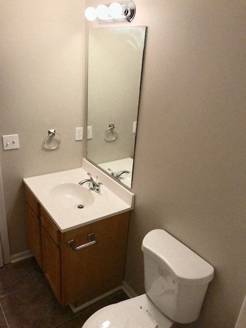 a bathroom with a toilet and a sink and a mirror