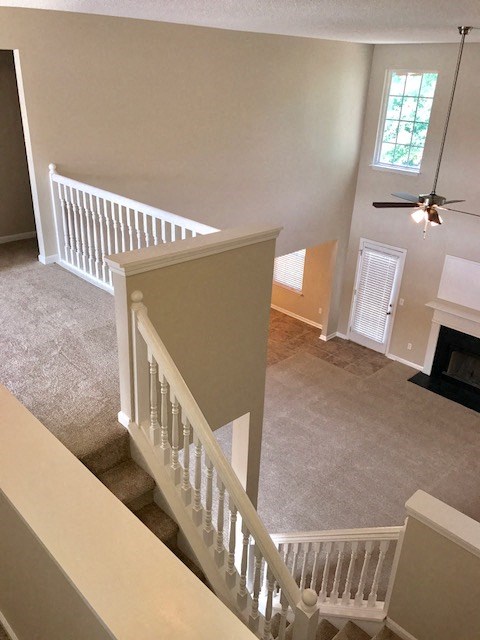 a staircase in a home with a ceiling fan