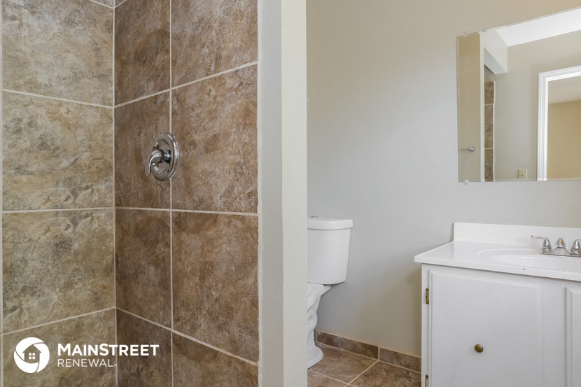 a bathroom with a shower and a sink and a toilet