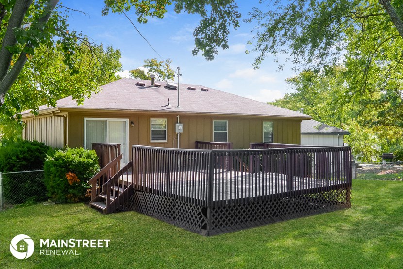 a house with a deck and a fence
