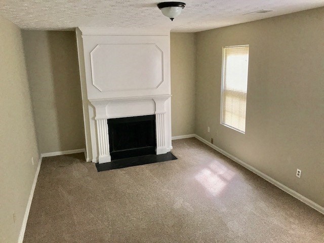 an empty living room with a white fireplace
