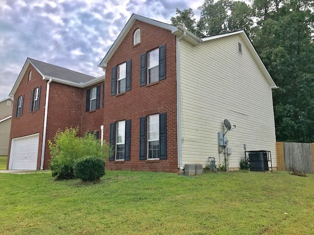a brick and with a grassy yard