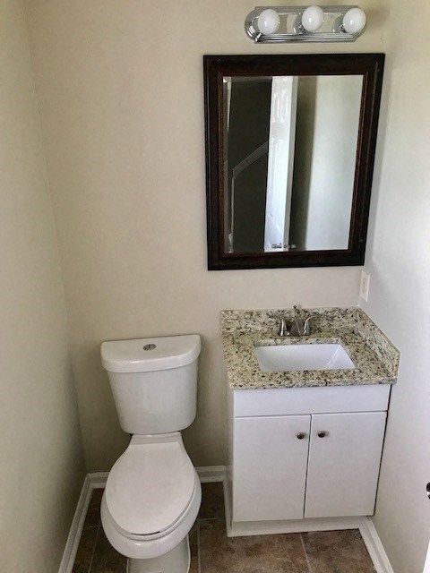 a bathroom with a toilet and a sink and a mirror