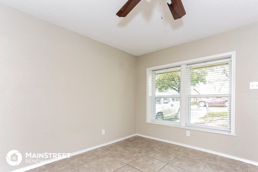 the living room of an empty home with a large window