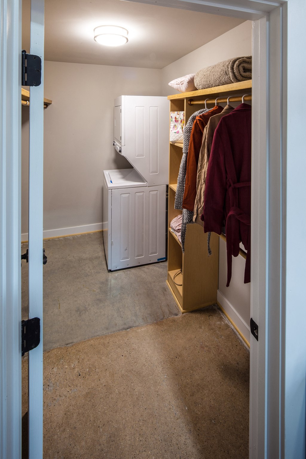 a room with a closet and a washer and dryer in it