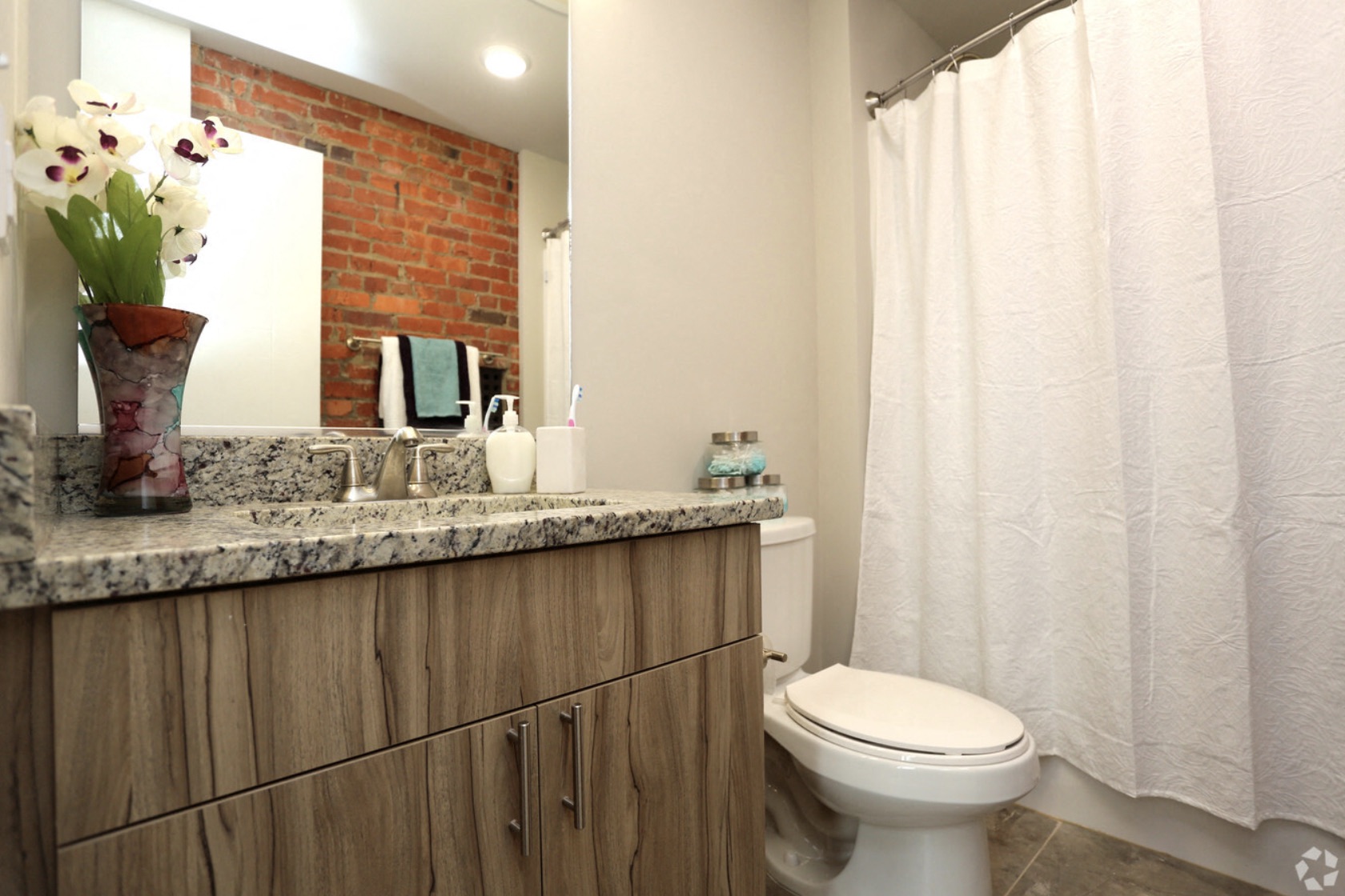 a bathroom with a toilet and a sink and a shower