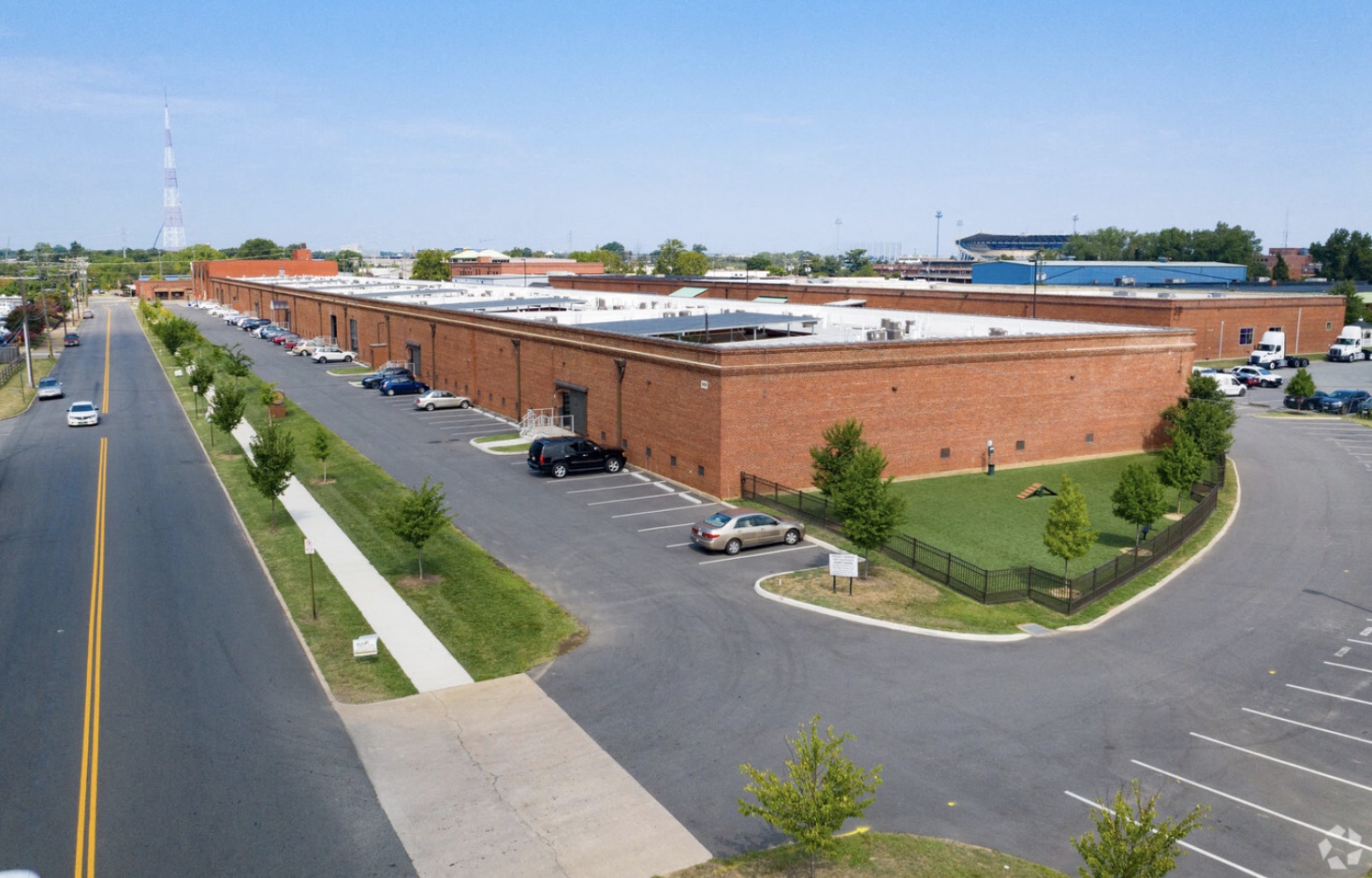 an empty parking lot in front of a brick building