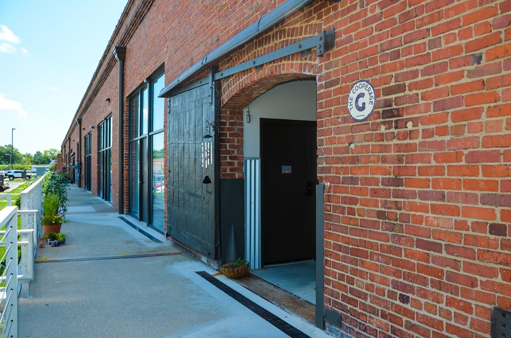 the side of a brick building with an open door