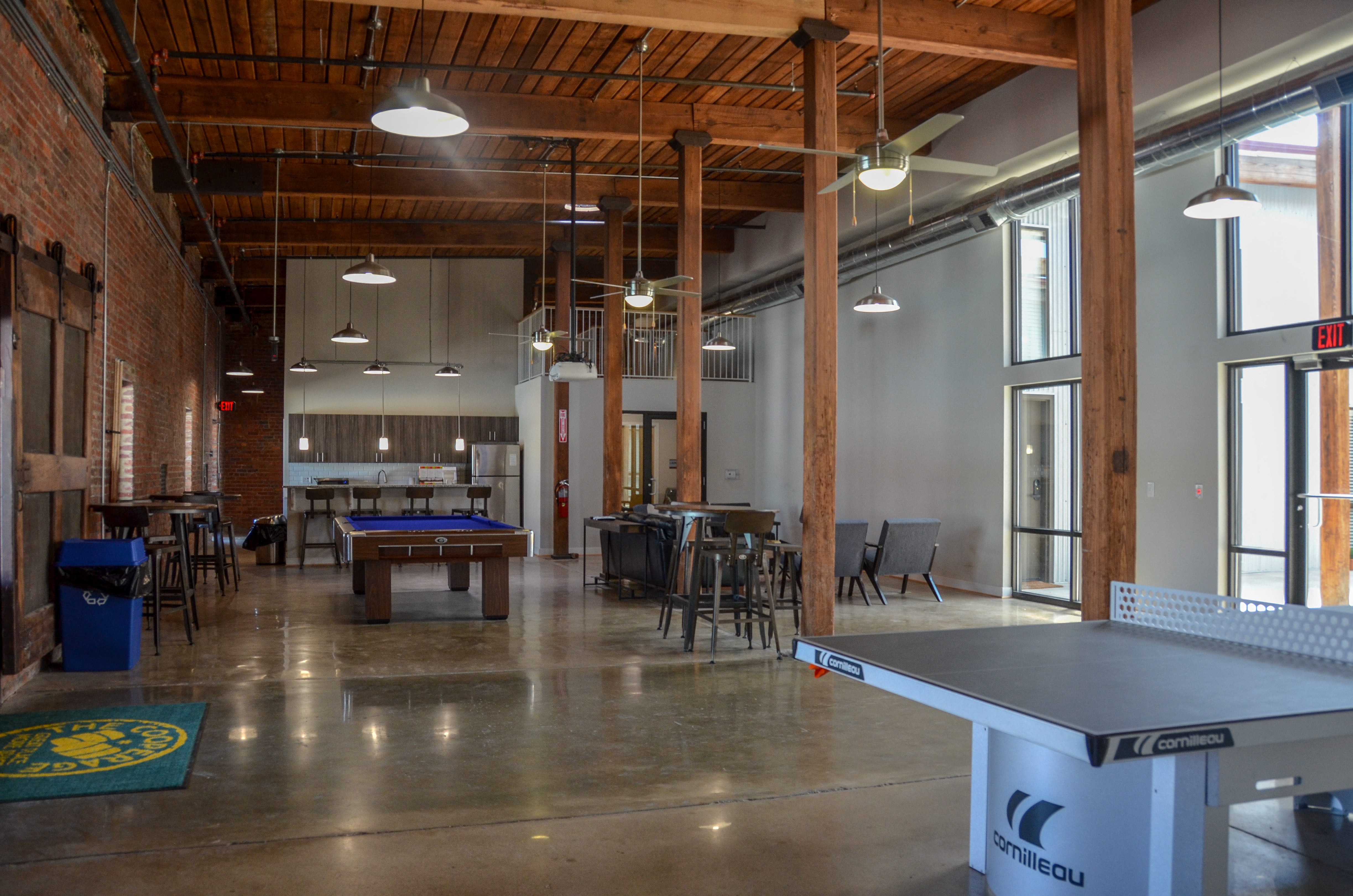 a game room with a pool table and tables