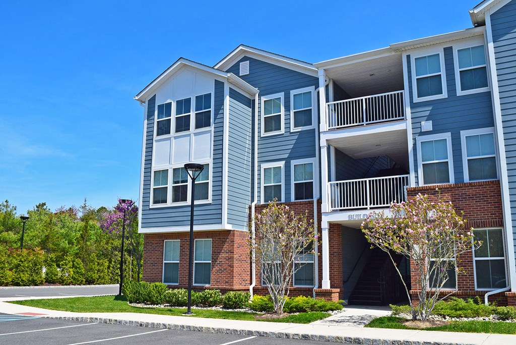 an exterior view of an apartment building on a sunny day