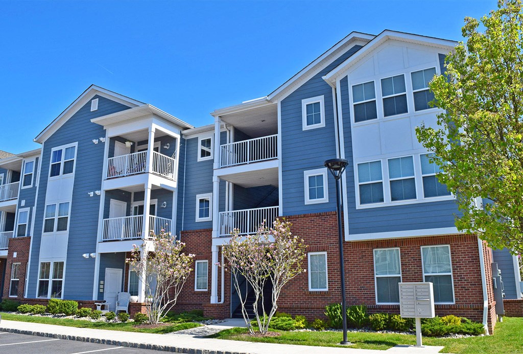 an exterior view of an apartment building on a sunny day
