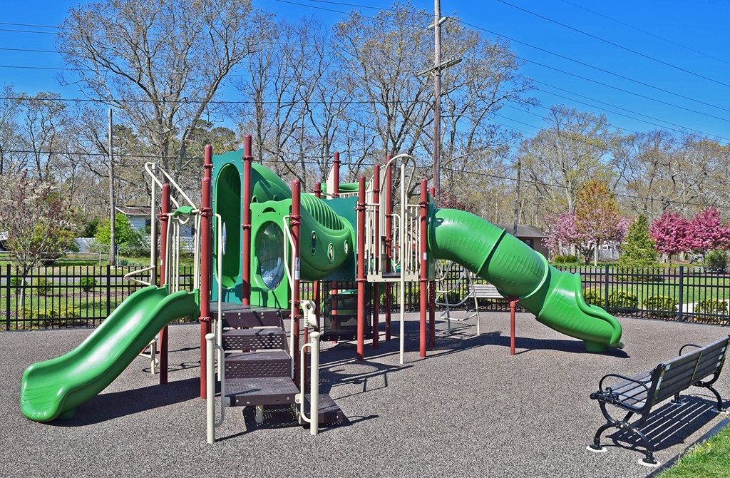 a playground with slides and a bench