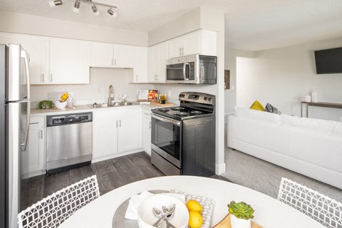 A modern kitchen with stainless steel appliances and white cabinets.