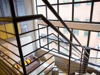 a stairwell with a view of a window and some stairs