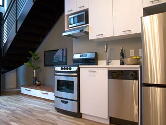 a kitchen with stainless steel appliances and white cabinets