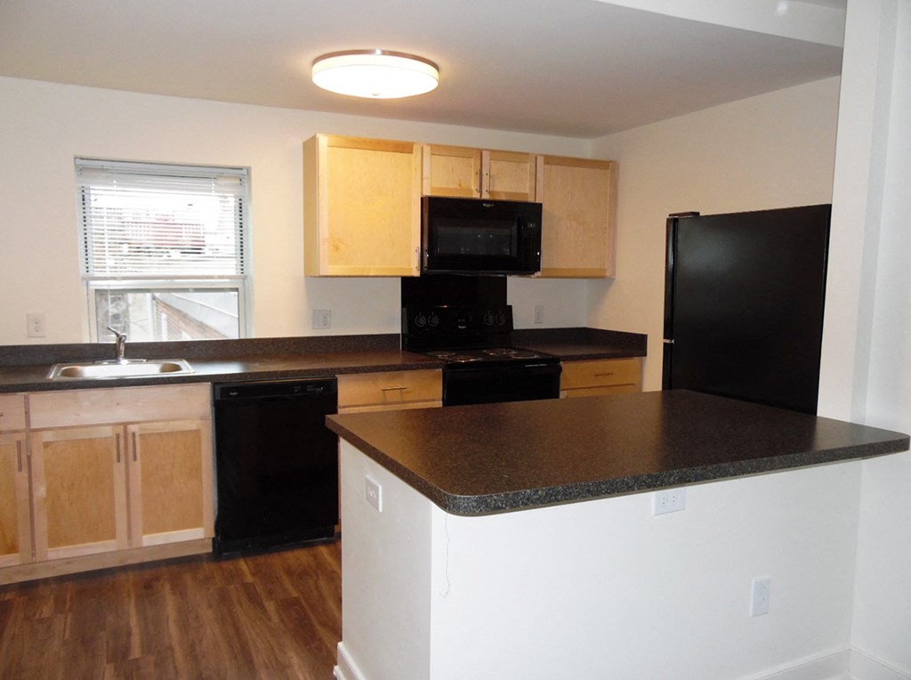 a kitchen with a counter top and a refrigerator