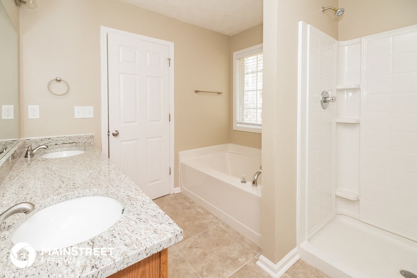 a bathroom with a sink and a tub and a shower