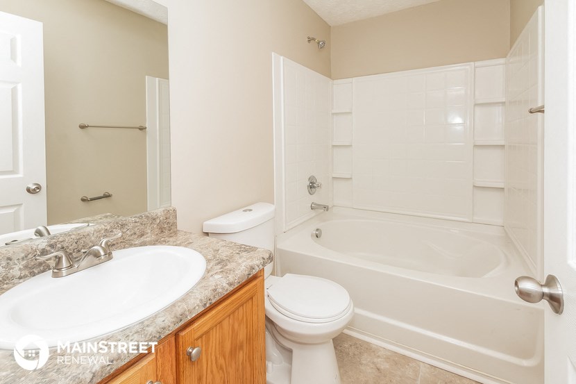 a bathroom with a sink toilet and a bath tub