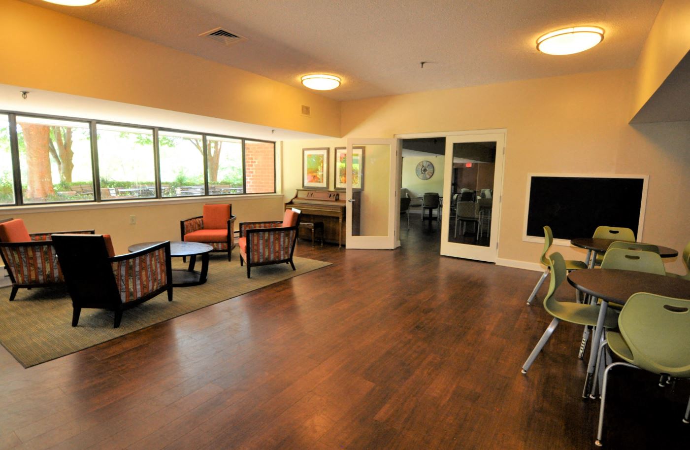a living room with a tv and a table and chairs