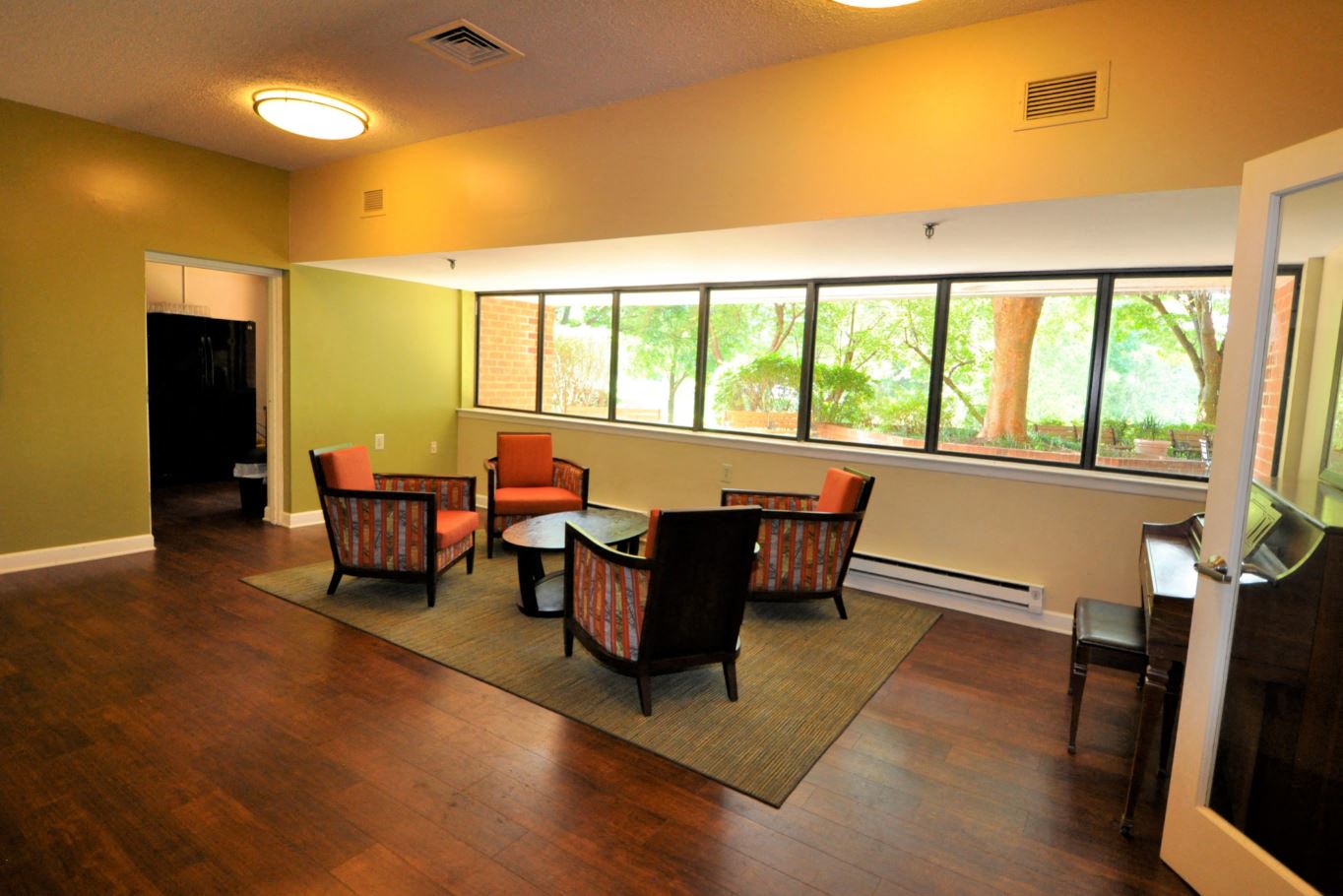 a living room with chairs and a table