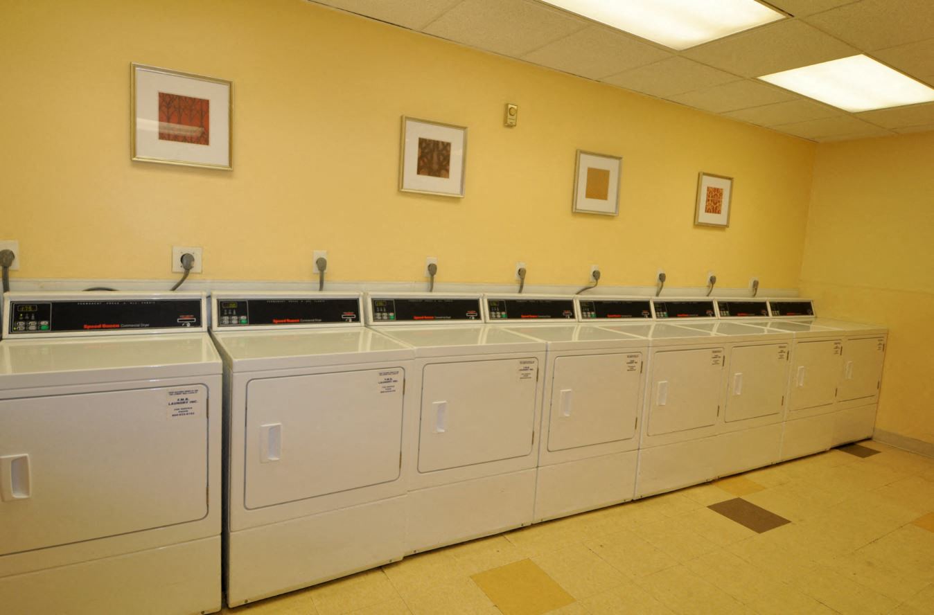 the laundry room is full of washers and dryers