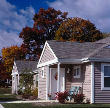 a small house with a bench in front of it